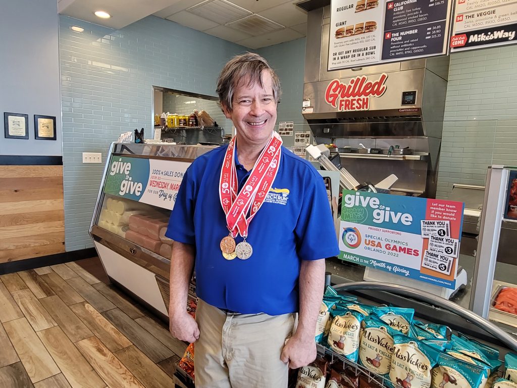 Jersey Mikes - Athlete smiling in front of counter