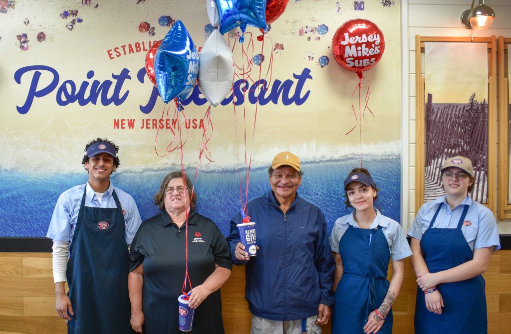 Jersey Mikes - People holding a Jersey Mike's cup with balloons