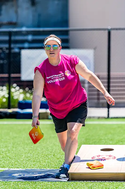 Event - Cornhole Classic - female tossing a bean bag front view