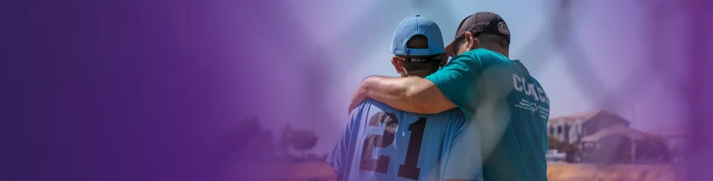 Volunteer Banner Image of a coach embracing an athlete
